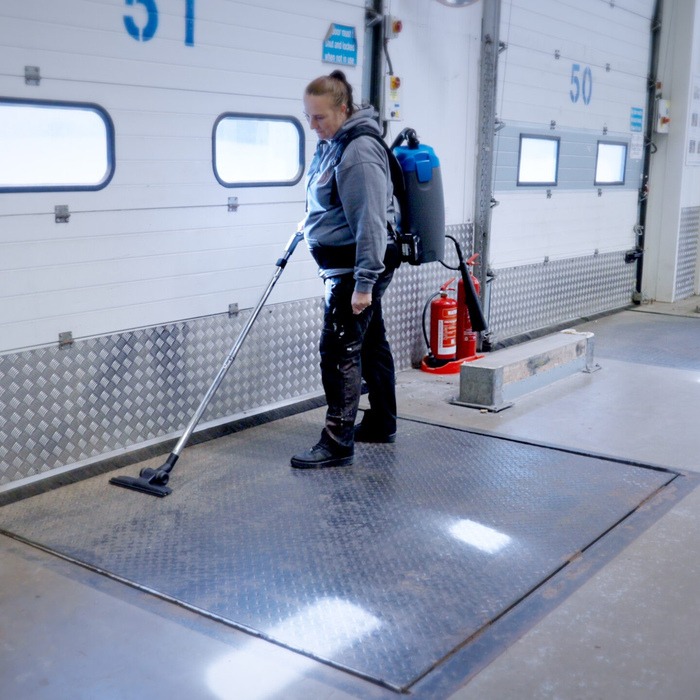 Gulvrengøring med skyVac Bacuum rygstøvsuger i en garage